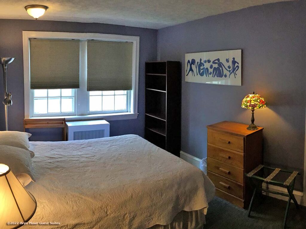 One bedroom features a queen size bed and television.